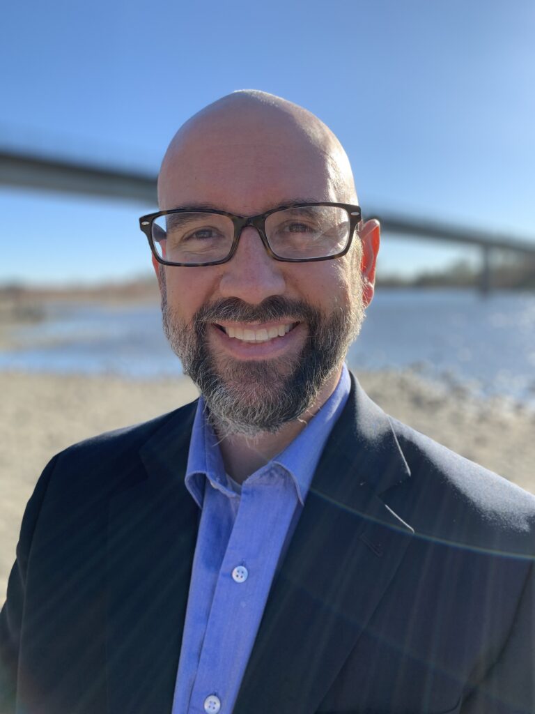 Eric Thronson standing by the Golden Gate bridge